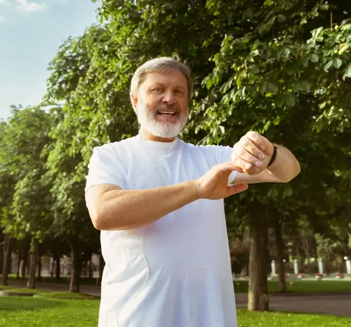 A man outdoors holding the supplement bottle